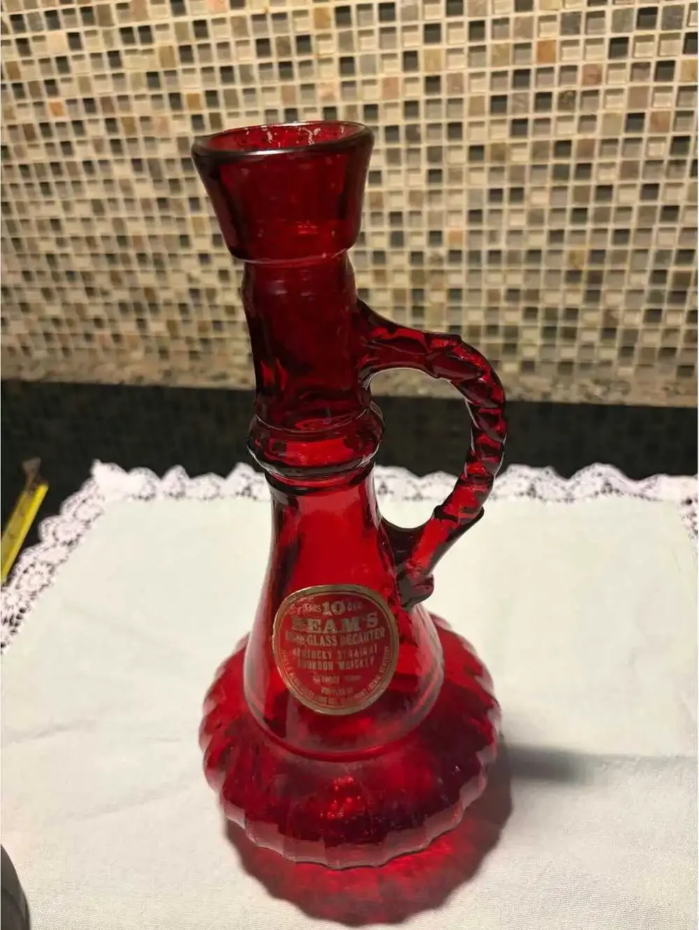 This is a vintage 1970s Jim Beam ruby red glass genie decanter.